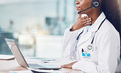 Closeup african american woman doctor using her laptop to do an online remote consult while sitting in her office in the hospital. Testing during the pandemic outbreak. Stop the spread of covid 19