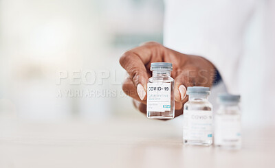 Buy stock photo Hand, woman and doctor with covid vaccine bottle and working in her hospital office. Healthcare expert with a bottle, wellness or corona medicine in a medical research clinic for safety from covid 19