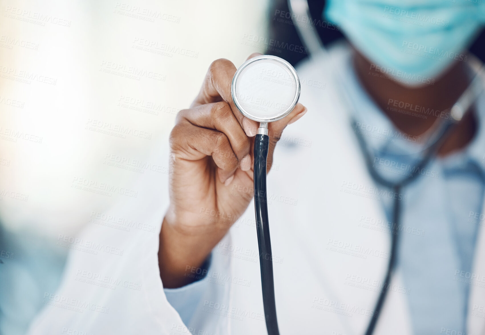 Buy stock photo Stethoscope, covid and hand of hospital doctor or cardiology expert ready to listen to heartbeat. Black woman, medical healthcare worker or employee with mask prepared to do heart check, test or exam