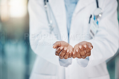 Closeup hands of african american woman doctor standing and holding copyspace in the hospital. Endorsing your lifestyle products. Use this product daily. Health and safety in the field of medicine