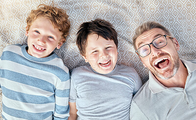 Buy stock photo Carefree loving father from above relaxing with his cute little playful sons. Happy caucasian family bonding together. Cheerful kids spending quality time with single dad