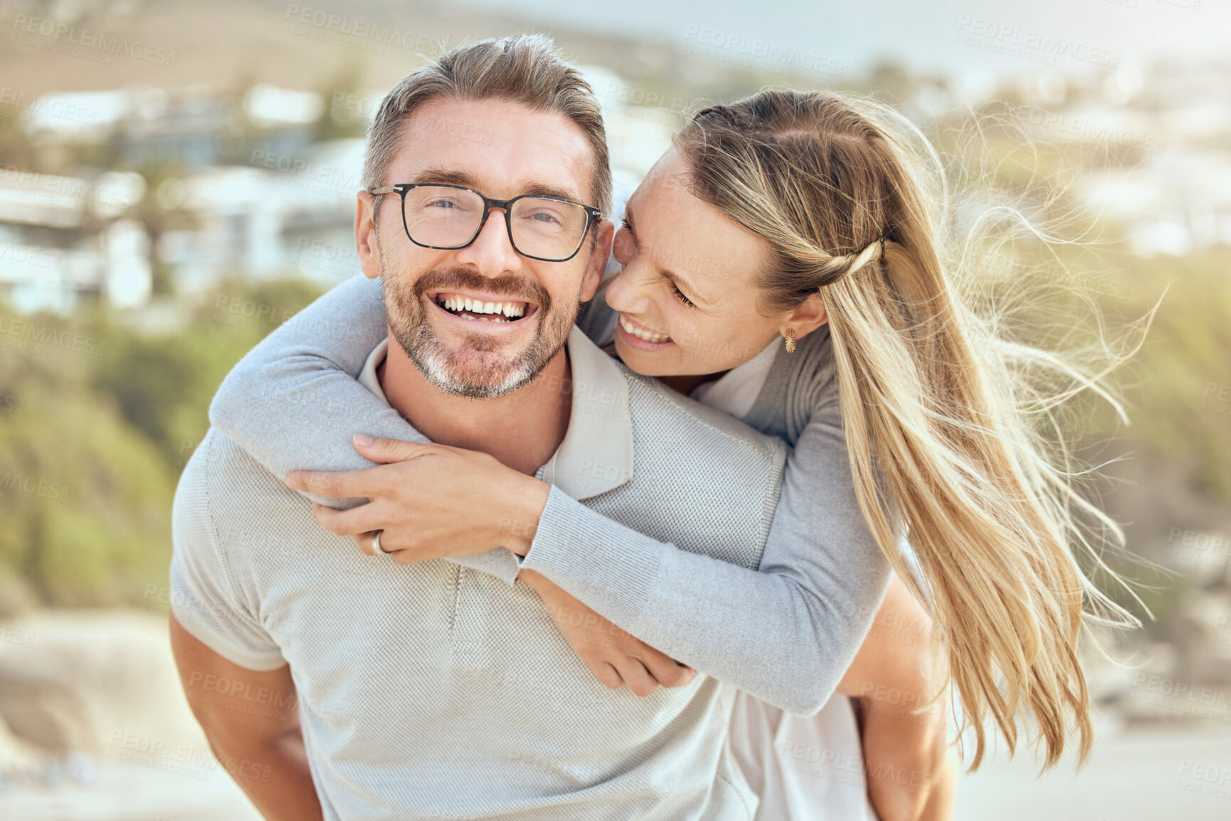 Buy stock photo Beach, piggy back and couple with love, relationship and happiness with romantic holiday, weekend trip and marriage. Portrait, mature man and woman with a smile, hug and seaside vacation with romance