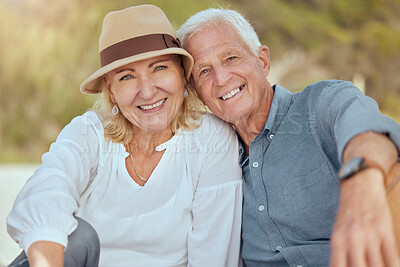 Buy stock photo A happy mature caucasian couple enjoying fresh air on vacation at the beach. Smiling retired couple sitting and having a romantic picnic in a garden or backyard