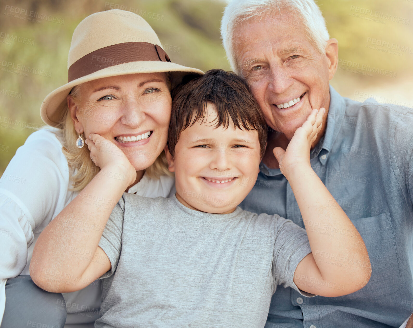 Buy stock photo Happy caucasian grandparents sitting with grandson on a beach. Adorable, happy, child bonding with grandmother and grandfather in a garden or park outside. Boy with foster parents