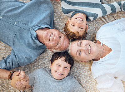Happy caucasian grandparents lying with grandsons on a beach. Adorable, happy, children bonding with grandmother and grandfather in a garden or park outside. Family taking selfies together