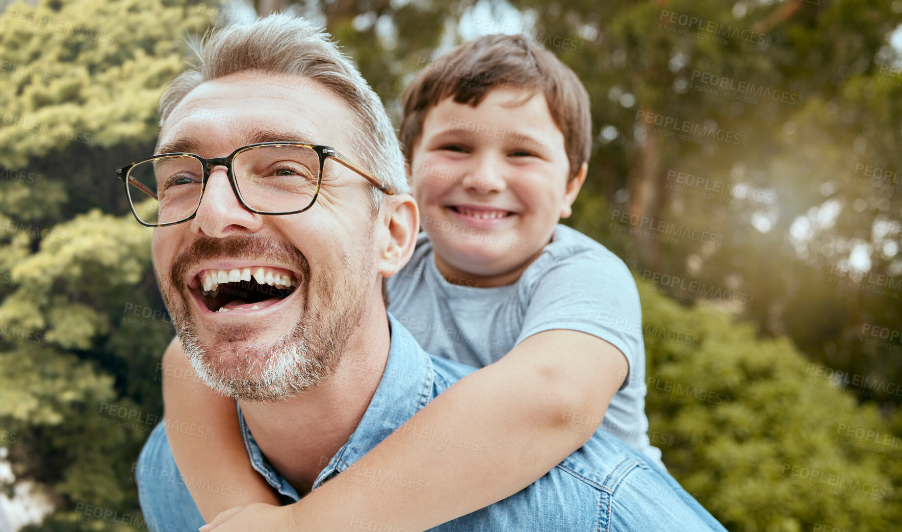 Buy stock photo Family fun, piggyback and father with child in a park happy, playing and laughing in nature. Hug, love and parent carrying son in a garden, laugh and enjoying games, smile and together on the weekend