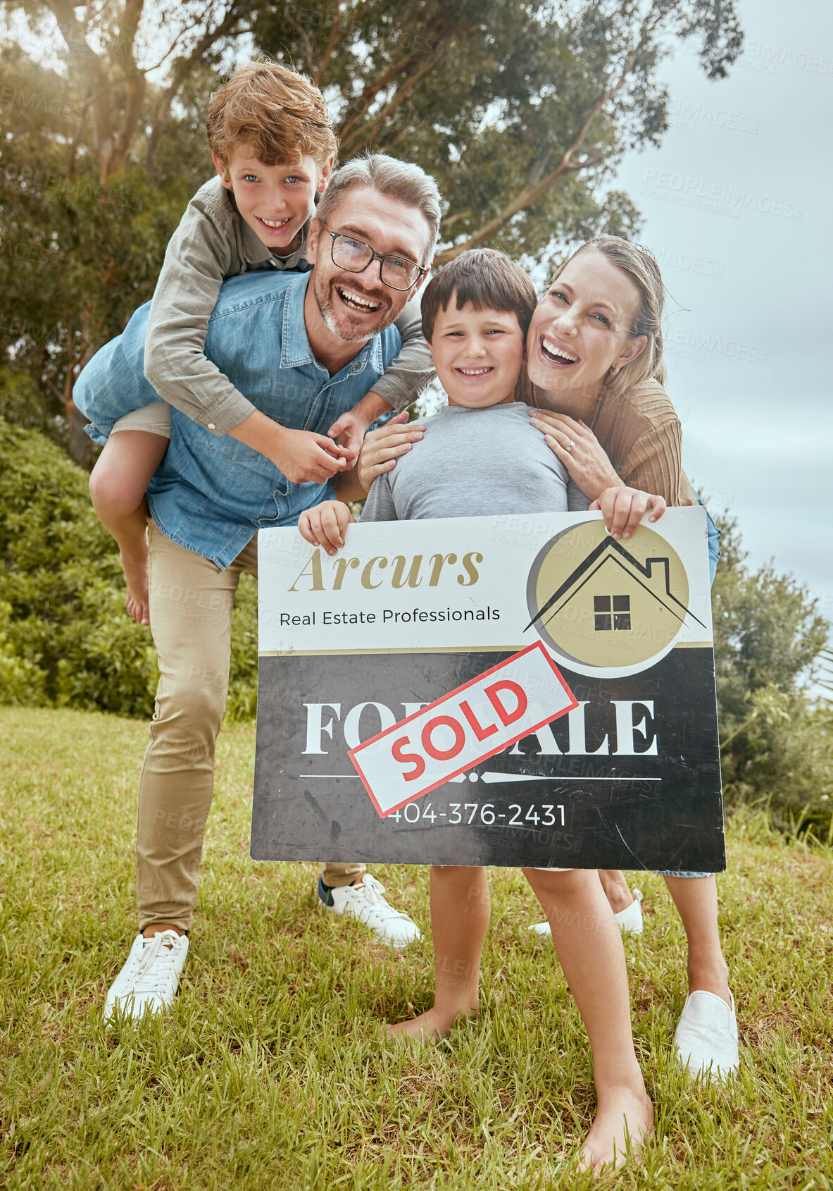 Buy stock photo Parents, kids and property with sold sign, portrait and smile for new home, start and investment for future. Father, mother and boy children with sale poster, real estate investing and family house