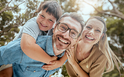 Portrait of a happy caucasian family of three being playful outside in a garden together. Smiling family bonding with their son in a backyard outside ad having fun