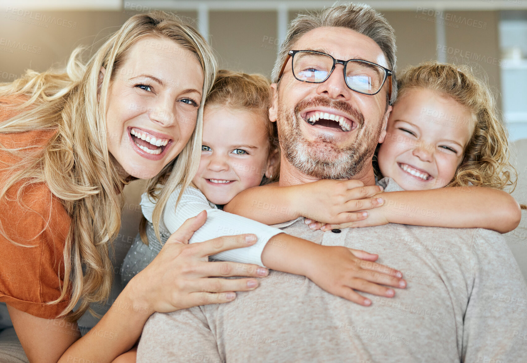 Buy stock photo Parents, portrait and couch with hug, kids and smile with love, bonding and care in family home together. Father, mother and daughters with happiness, embrace and relax on living room sofa in house