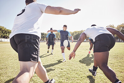 Buy stock photo Mixed race rugby player attempting a dropkick during a rugby match outside on the field. Hispanic man kicking for touch or attempting to score three points during a game. Getting his team up the field