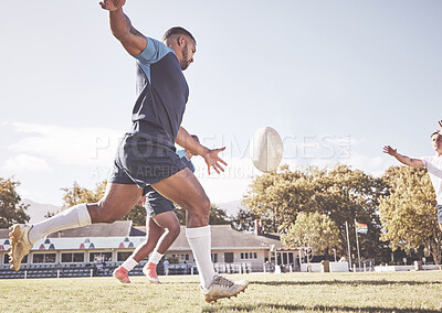 Buy stock photo Mixed race rugby player attempting a dropkick during a rugby match outside on the field. Hispanic man kicking for touch or attempting to score three points during a game. Getting his team up the field