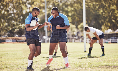 Buy stock photo Two african american rugby teammates celebrating scoring a try or winning a match outside on a sports field. Rugby players cheering during a match after scoring. Teamwork ensures success and victory