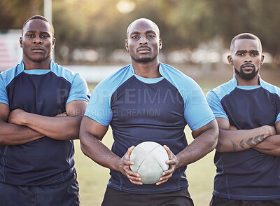 Buy stock photo Portrait three young african american rugby players holding a rugby ball while standing outside on the field. Black men looking confident, ready for the match. Athletic sportsmen focused on the game