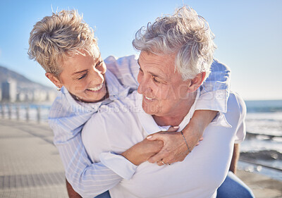 Buy stock photo A happy mature caucasian couple enjoying fresh air on vacation at the beach. Smiling retired couple getting a cardio workout while being playful and having fun together on a romantic date