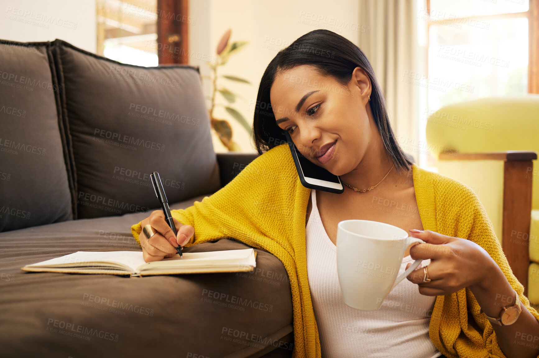 Buy stock photo Phone call, coffee and woman writing in notebook in home on sofa for notes, research and conversation. Cellphone, book and female person talking or speaking with contact for information in lounge.