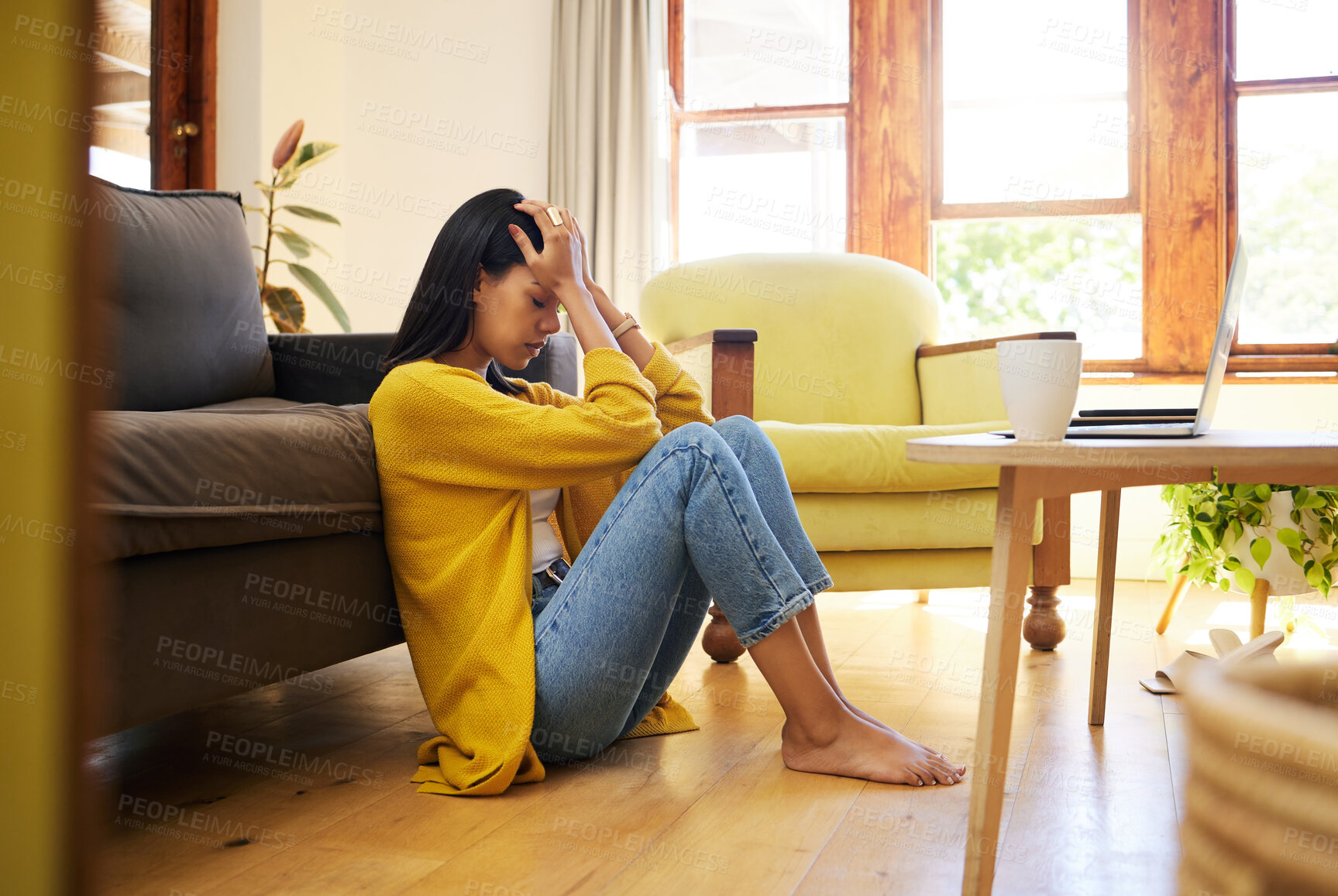 Buy stock photo Stressed woman, depression and lonely in the living room sitting on the floor at home. Young sad female suffering from mental health issues and anxiety or headache in apartment or house