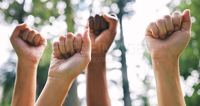 Buy stock photo Peoples fist in the air outside in nature. Closeup of a group of peoples fist in the air as a concept of empowerment. Diverse people with their fists in the air