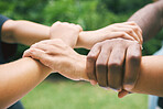 Hands holding wrists outside in nature. A diverse group of people holding wrist as a concept of loyalty. Closeup of a multiethnic group holding wrists