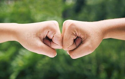 Buy stock photo Closeup of a fist bump outside in nature. Two diverse peoples hands greeting. Fist bump in nature