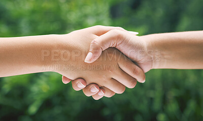 Buy stock photo Closeup of a handshake in nature. Two diverse peoples hands greeting. Partners making an agreement about sustainability