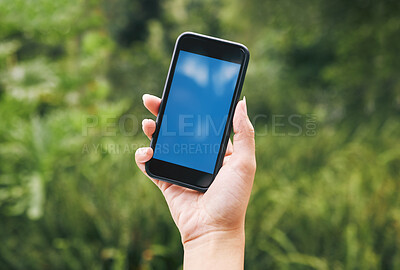 Buy stock photo Nature, hand of woman with phone and mockup or green screen, contact us outside. Outdoor plants, leaves in background and smartphone in hands with 5g wifi internet connection and business information