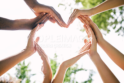 Buy stock photo Hands, heart and emoji with a group of people outdoor together in summer for love or solidarity. Social media, icon and hand gesture with friends outside in nature for sustainability or bonding