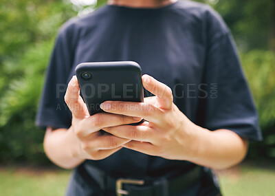 Buy stock photo Closeup of someone typing on a phone outside in nature. A person texting and using facebook. Someone using a mobile phone device and browsing the internet