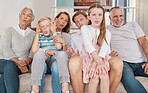 Portrait of a happy family sitting on the couch and making funny faces in the living room at home. Joyful little girl and boy bonding with parents and grandparents in the living room