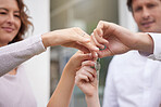 Closeup hands of happy married couple holding up house keys. Man and woman holding keys to new house or apartment. Young family buying or renting new house and moving in together, loan or mortgage