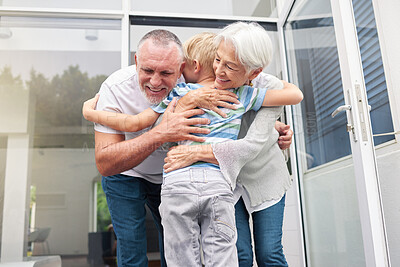 Buy stock photo Senior grandparents hugging their small grandson at home. Little boy bonding and embracing smiling grandmother and grandfather. Adopted child feeling happy and grateful while hugging elderly couple