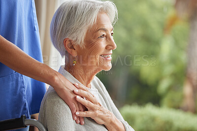 Caring nurse supporting senior woman in an old age home with copyspace. Smiling elderly woman feeling happy and touching a medical aid\'s hand. Disabled woman in a wheelchair bonding with her caregiver