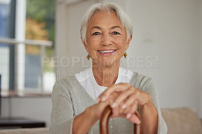Buy stock photo Retired senior woman relaxing at home. Happy smiling old woman holding walking cane and looking at the camera with positivity. Carefree and mature grandmother sitting on chair in nursing home