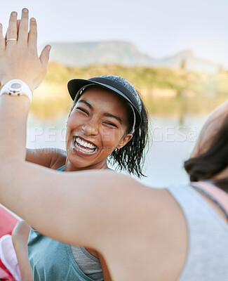 Buy stock photo A cheerful woman is positive and motivating while out kayaking and enjoying water activity on a lake with her partner. Close up of two active friends giving high five while celebrating outdoors. 
