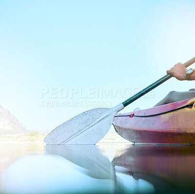 Closeup of kayak oar paddle rowing on calm water. Female hands kayaking on a lake during summer break. Woman outside in nature enjoying water activity. Training and practicing for a kayak race