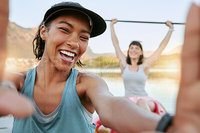 Buy stock photo Two smiling friends taking selfies and kayaking together on a lake in summer break. Smiling happy playful women bonding outside in nature with water activity. 