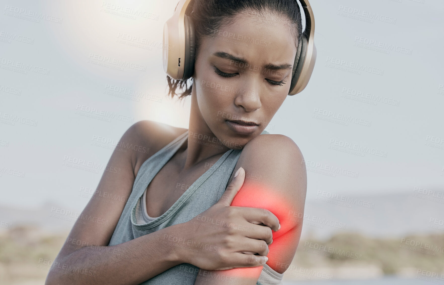 Buy stock photo Female athlete with a shoulder pain after an intense workout. Young sports woman with an injury or hurt arm highlighted in red. An athletic female suffering from inflammation or stiff muscle