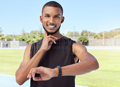 Buy stock photo Young athlete using a fitness tracker to monitor progress, heart rate and calories burned during a workout. Portrait of a sportsman checking his pulse with a digital watch while training for exercise