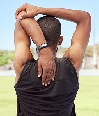 Buy stock photo Athletic man preparing for fitness and exercise by stretching and warming up outside on a sports field. Male athlete going through his warmup routine before exercise or a cardio or endurance workout