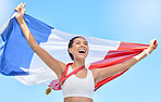 Young athlete cheering and holding French flag after competing in sports. Smiling fit active sporty woman feeling motivated and celebrating achieving gold medal in olympic sport. Raising national flag