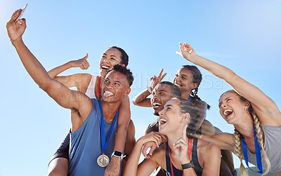 Buy stock photo Group of diverse olympic athletes taking a selfie while having fun and showing hand gestures. Happy and cheerful runners taking a photo together. Young male sprinter taking a picture with athletes