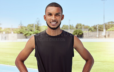 Buy stock photo Portrait of a fit active young athlete standing alone before going for a run on a track field. Latino male looking confident and smiling outside getting ready to do his daily routine exercise outside