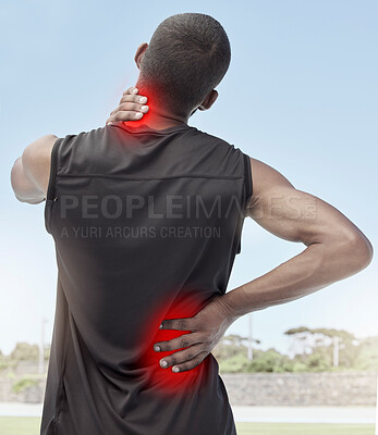 Buy stock photo Injured and sore male runner suffering from sudden ache in his neck and back. Muscle strain or injury after a routine workout outdoors. Young sportsman struggling with unbearable pain during practice