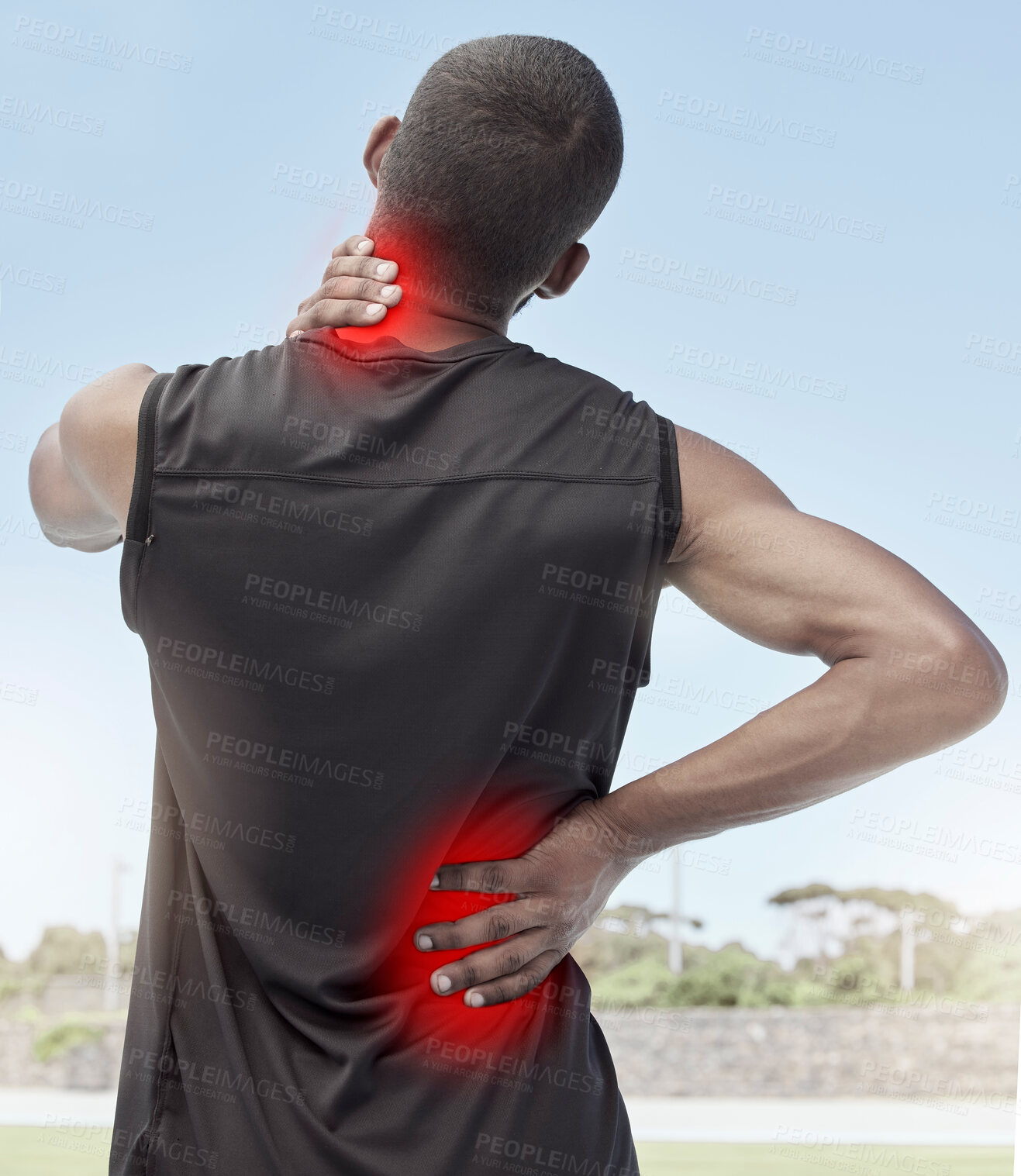 Buy stock photo Injured and sore male runner suffering from sudden ache in his neck and back. Muscle strain or injury after a routine workout outdoors. Young sportsman struggling with unbearable pain during practice