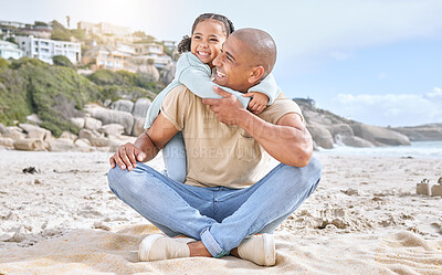 Buy stock photo Shot of adorable little cheerful girl hugging her father from behind while bonding together at the beach. Carefree dad having fun with playful daughter during summer seaside vacation on the shore
