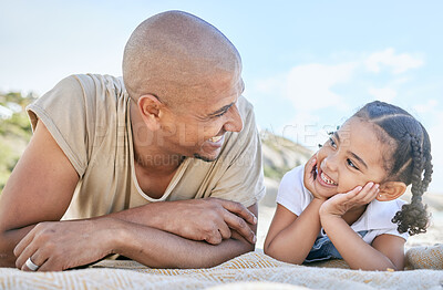 Buy stock photo Smiling single father and little daughter looking at each other while relaxing on a beach. Adorable girl bonding with her dad and enjoying vacation. Man and child having fun and enjoying family time 