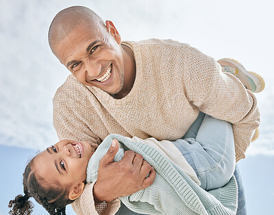 Buy stock photo Portrait of cheerful Latino father from below carrying his cute little daughter while bonding together outdoors. Happy man and playful girl having fun while enjoying quality family time together