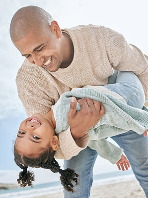 Buy stock photo Smiling mixed race single father carrying little daughter on the beach. Adorable, happy, latin girl bonding with parent and playing on beach. Man and cute child enjoying free time