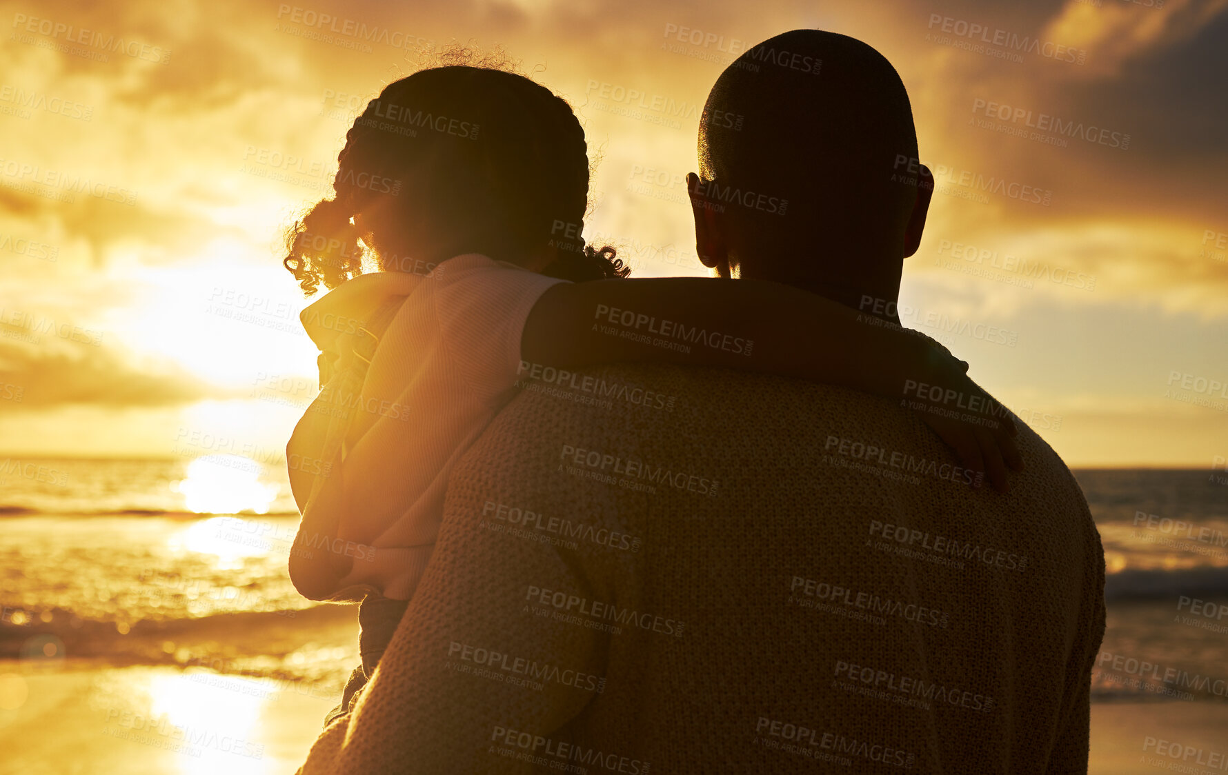 Buy stock photo Silhouette of a loving father and daughter watching the view at sunset. Family looking at the beautiful golden sky while on holiday. Little girl and dad bonding and enjoying time together on vacation