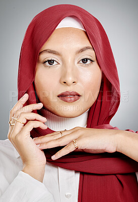 Closeup portrait of a beautiful muslim woman posing in a studio with a hijab. Headshot of a stunning confident arab model isolated against a grey background. Zoomed in on fashionable middle eastern
