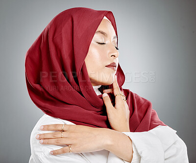 Buy stock photo Beautiful muslim woman posing in studio wearing hijab. Headshot of stunning confident arab model standing against grey background. Fashionable woman wearing a headscarf. Elegant female in a headwrap